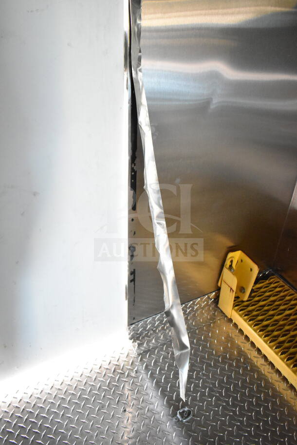 2020 Ford F59 food truck interior, visible hatch access, diamond plate floor, metal panel, and strip.