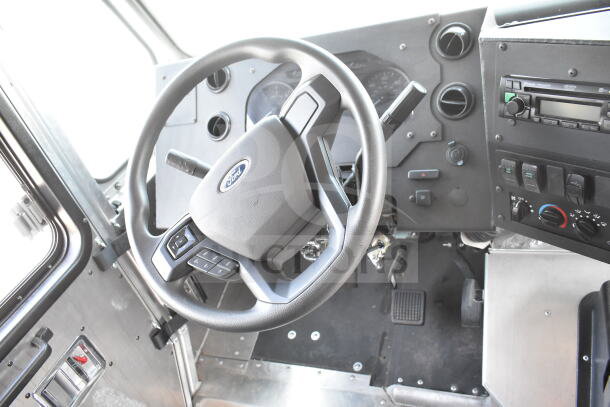 2020 Ford F59 food truck dashboard, showing steering wheel and controls. Includes grease hood, Pitco fryer, chef base. VIN 1F66F5KN8L0A07302.