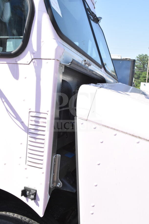 2020 Ford F59 food truck, partial side view with open panel, showcasing robust build, VIN 1F66F5KN8L0A07302.