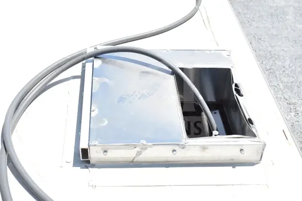 Rooftop view of a 2020 Ford F59 food truck exhaust vent, showing metal casing and electrical conduits.