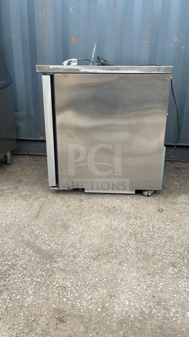 True TUC-27-HC undercounter refrigerator, stainless steel, good condition, 27 5/8" width, on casters, energy-efficient model.