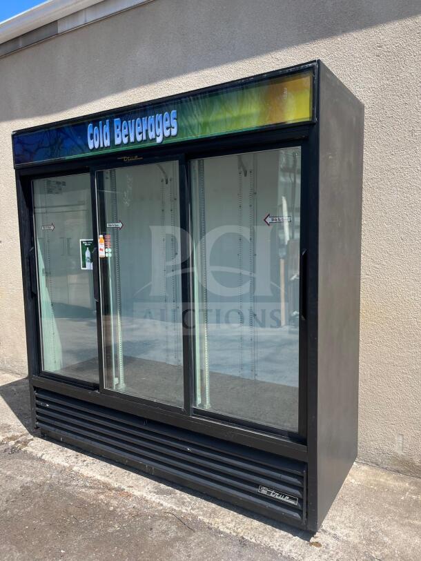 True GDM-69 merchandiser, 78 1/8" wide, three sliding glass doors, black, used condition, 115v, "Cold Beverages" signage.