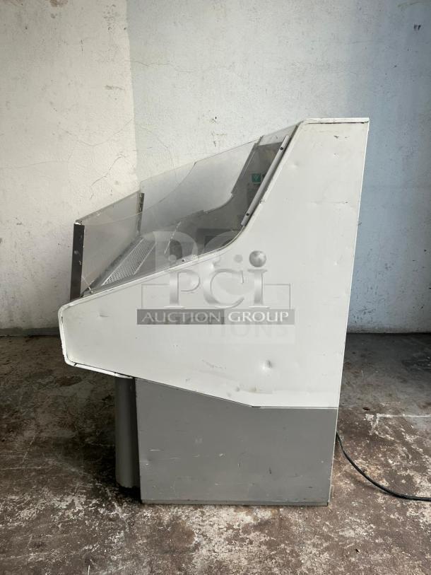 Grab & Go Open Top Display Cooler in steel/white, tested and working, side view. Visible logo: PCI Auction Group. Signs of wear.