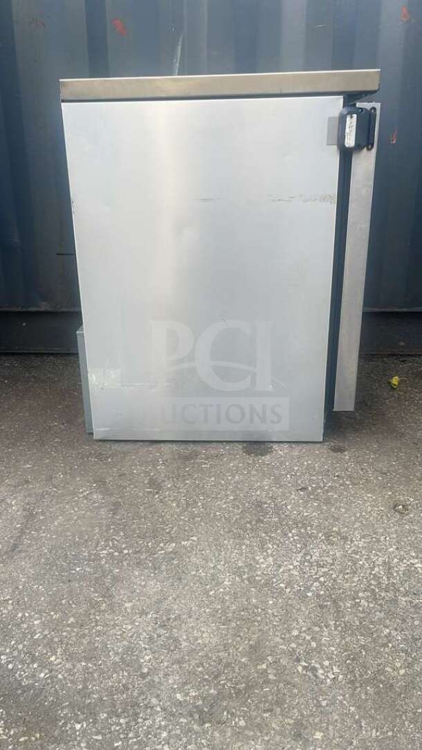 True TUC-24-HC 24" undercounter refrigerator, stainless steel, visible wear, outdoor setting, single door.