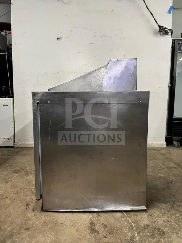 72" preptable stainless steel sandwich/salad prep table with mega top, refrigerated base. Model 72, visible wear.