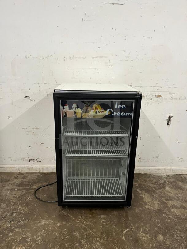 White countertop display ice cream freezer with glass door. Excellent condition, three wire shelves, decorative ice cream signage.