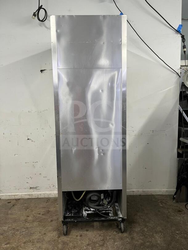 TRUE T-23-2 refrigerator with two left hinge solid doors, visible wear and dents, 115V, model label not shown.