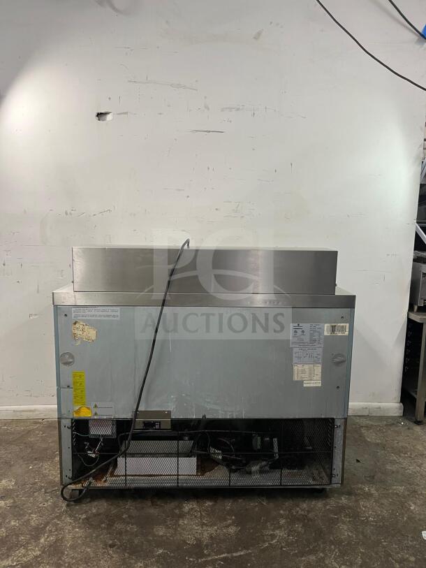 Kelvinator KCHMT48 48" prep table with refrigerated base, used condition. Visible power cord, labels indicate model and specifications.