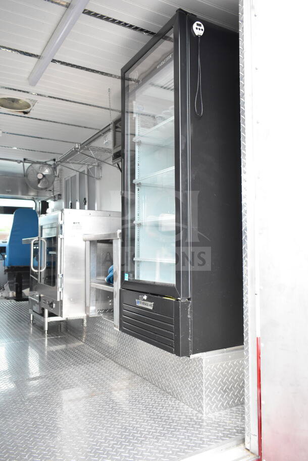 1993 GMC Step Van interior with commercial kitchen equipment, featuring a Beverage-Air refrigerator and stainless steel oven.