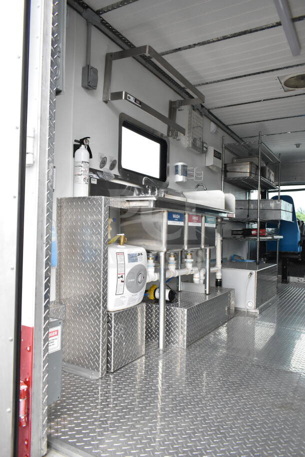 1993 GMC Step Van interior, featuring stainless steel sinks, labeled wash stations, and diamond plate flooring.