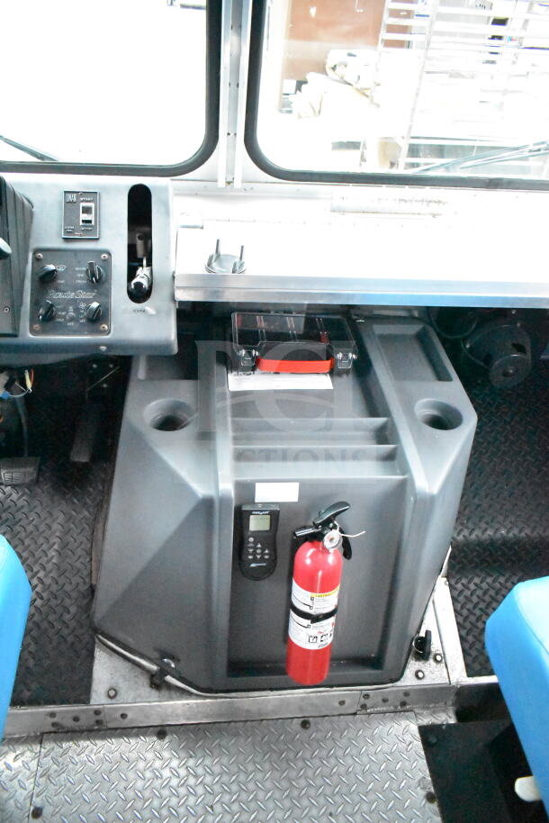 Interior of 1993 GMC Step Van showing the dashboard, control panel, and a mounted fire extinguisher.