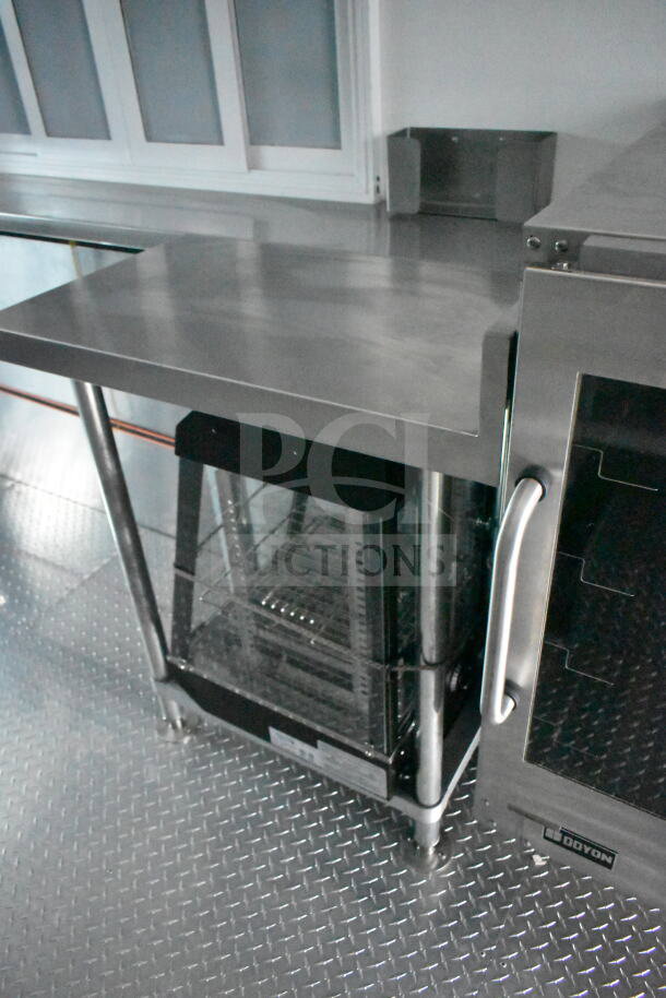 Interior view of 1993 GMC Step Van featuring stainless steel counter and Doyon oven. Clean, well-maintained setup.