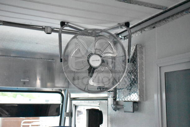 Interior of a 1993 GMC Step Van featuring a ceiling-mounted industrial fan. VIN: 1GDHP32K7R3500033.