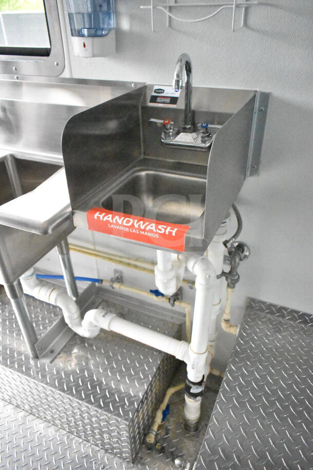 1993 GMC Step Van interior with stainless steel handwash sink, labeled "HANDWASH," chrome faucet, and visible plumbing.