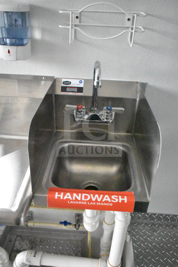 Interior sink of a 1993 GMC Step Van. Features stainless steel basin, Sauber label, and "Handwash" signage.