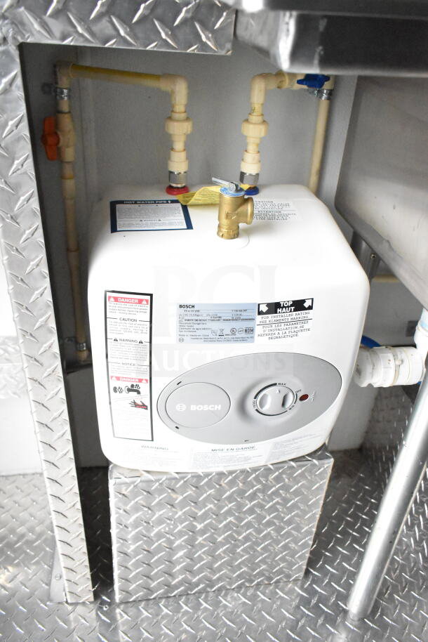 Interior of 1993 GMC Step Van showing a Bosch water heater with visible labels and plumbing connections.