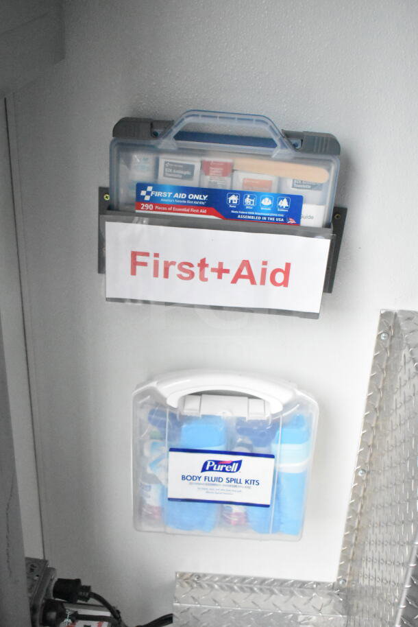 Interior view of the 1993 GMC Step Van featuring first aid kits. Includes "First Aid Only" and "Purell Body Fluid Spill Kits" labels.
