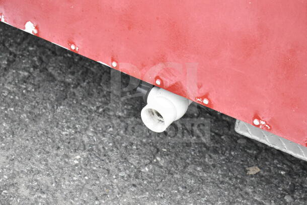 1993 GMC Step Van exterior showing red body panel with white drain pipe and visible rivets.