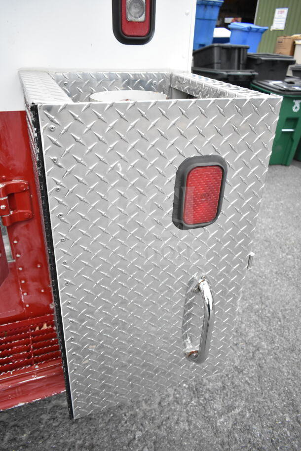 1993 GMC Step Van detail, featuring a diamond plate panel with red reflectors and chrome handle, VIN: 1GDHP32K7R3500033.