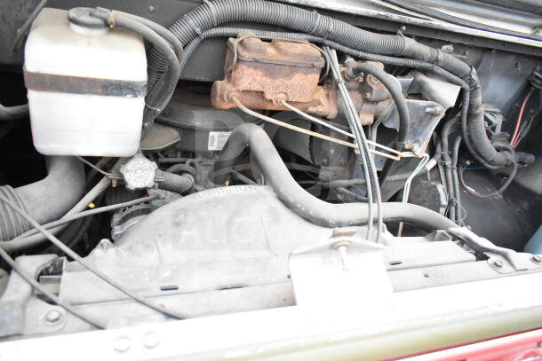 Engine compartment of a 1993 GMC Step Van; visible components show wear and rust. VIN 1GDHP32K7R3500033.