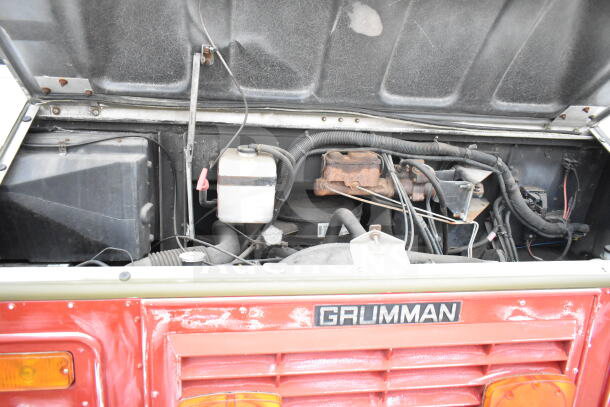 1993 GMC Step Van engine compartment view, showing mechanical components and Grumman badge, VIN 1GDHP32K7R3500033.