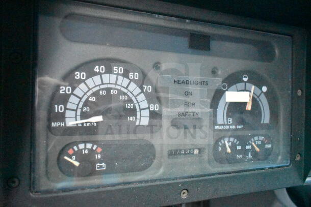 Dashboard of 1993 GMC Step Van showing speedometer, fuel gauge, and mileage at 117,436 miles. Labels indicate headlight use for safety.