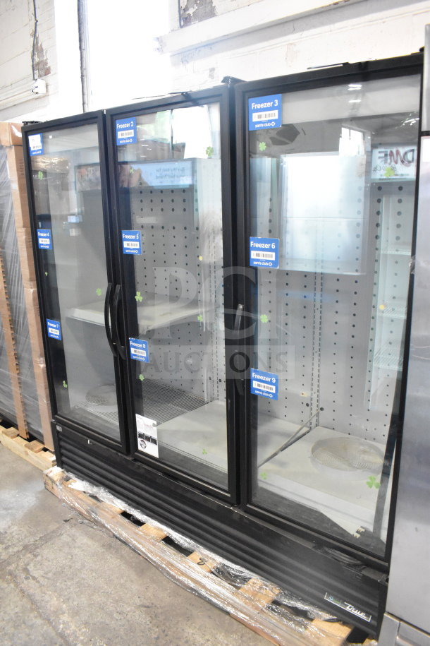 2019 True FLM-81F Commercial 81" glass door freezer merchandiser, excellent condition, visible store labels on doors.