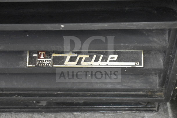 True GDM-12 commercial cooler merchandiser, single door, 115V, labeled "True T Manufacturing."