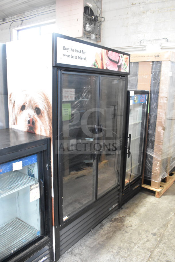 2021 True TVM-48SL-HC commercial 2-door cooler merchandiser, 115V, 1 phase, glass doors, black frame, excellent condition.