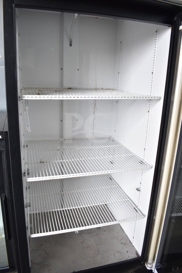 True GDM-26 Commercial Cooler, single glass door, interior shelves, visible wear, 115 volts, 1 phase.