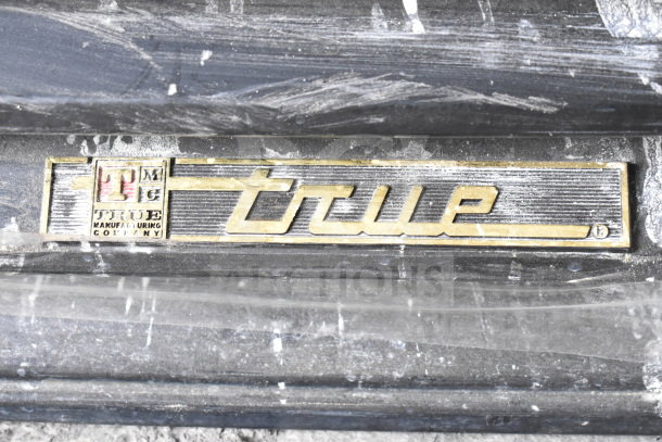 True GDM-26 cooler tag, showing brand logo. Commercial reach-in cooler, single door, 115 volts, 1 phase.