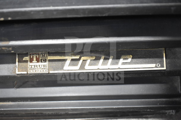True GDM-12 Commercial Cooler, black casing, visible True Manufacturing Company label. 115V, 1 Phase.