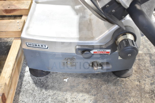 Hobart 2912 commercial countertop meat slicer, 120 volts, 1 phase. Visible dials and start/stop button on metal base. Used condition.