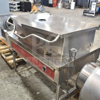 Commercial floor-style braising pan in stainless steel. Features a large tilting mechanism, control panel, and sturdy legs.