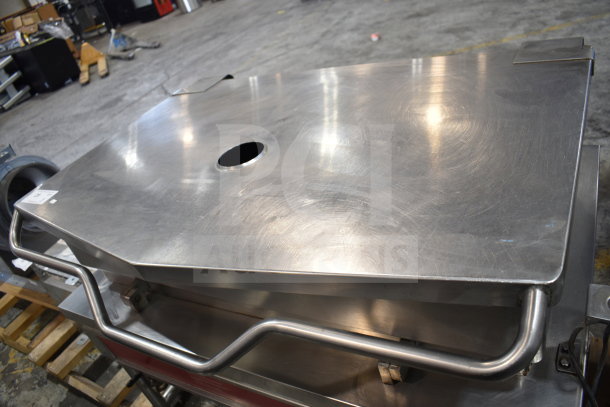 Commercial floor-style braising pan with stainless steel finish and sturdy handles, used condition, features a central hole in the lid.
