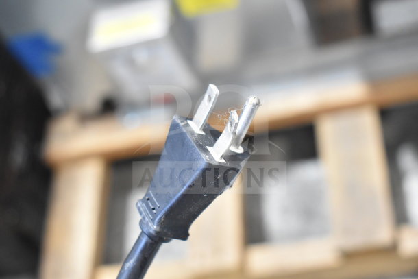 Close-up of the power plug for a Moffat Turbofan EHT10 holding cabinet, showing a standard three-prong design.