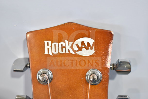 2 Rock Jam guitars with visible brand logo on the headstock. Includes tuning pegs and strings.