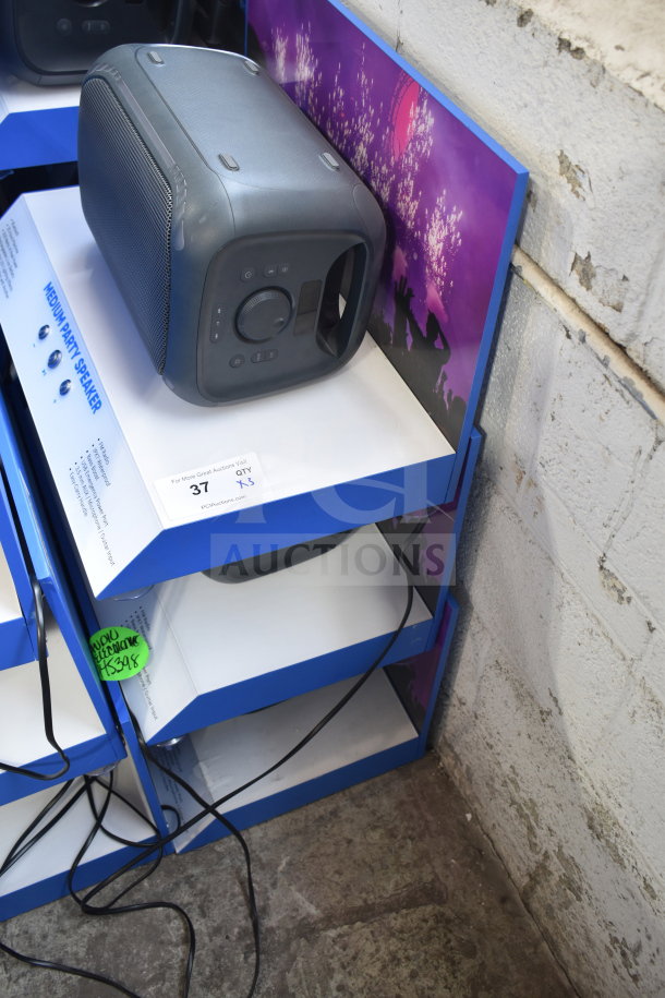 Onn Medium Party Speaker on a three-tier store display, showing control panel, wires, and signage offering three-times bid.