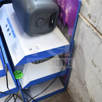 Onn Medium Party Speaker on a three-tier store display, showing control panel, wires, and signage offering three-times bid.