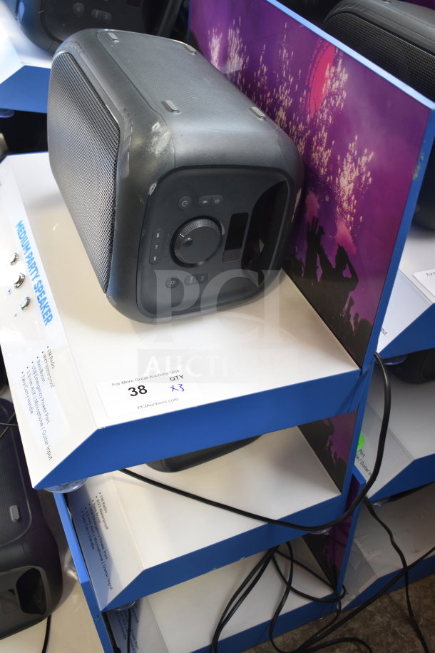 Onn Medium Party Speaker display, showing speaker controls and connectivity ports on a blue shelf.