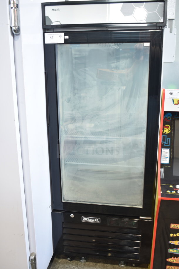 Brand new 2024 Migali C-10FM-HC freezer merchandiser, black single door, scratch and dent. 115V, 1 phase. Model details visible.