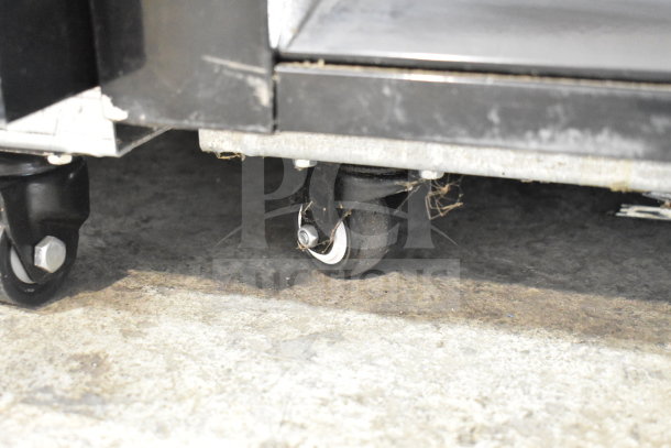 Migali C-12RM-HC commercial cooler caster, showing minor scratch and dent. Commercial-grade wheel for easy mobility.