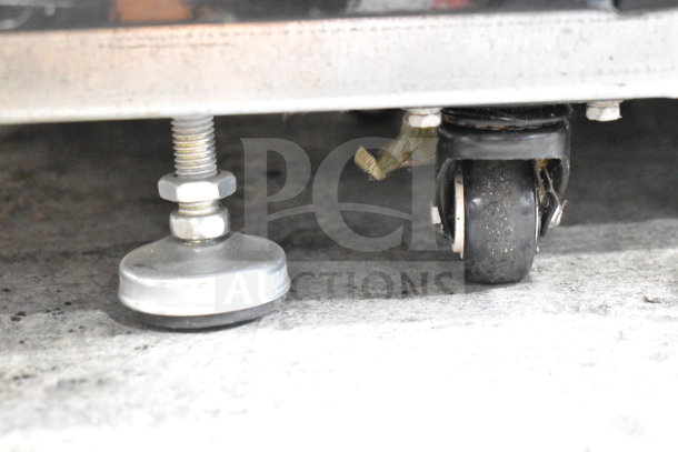Migali C-10RM-HC cooler caster and leveling foot detail, showcasing new condition and sturdy design.