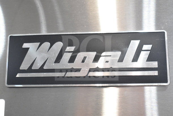 Migali C-3R-HC logo on stainless steel. Brand new commercial cooler with scratches and dents. 3 doors, on casters. 115V, 1 Phase.