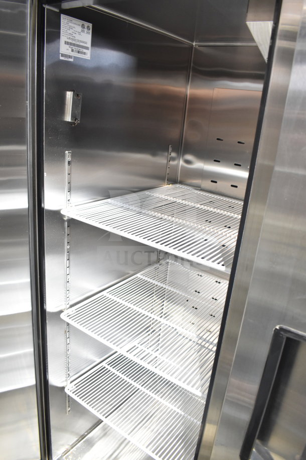 Brand new Migali C-3R-HC commercial 3-door cooler, scratch and dent, with metal shelves and commercial casters, 115V, 1 phase.