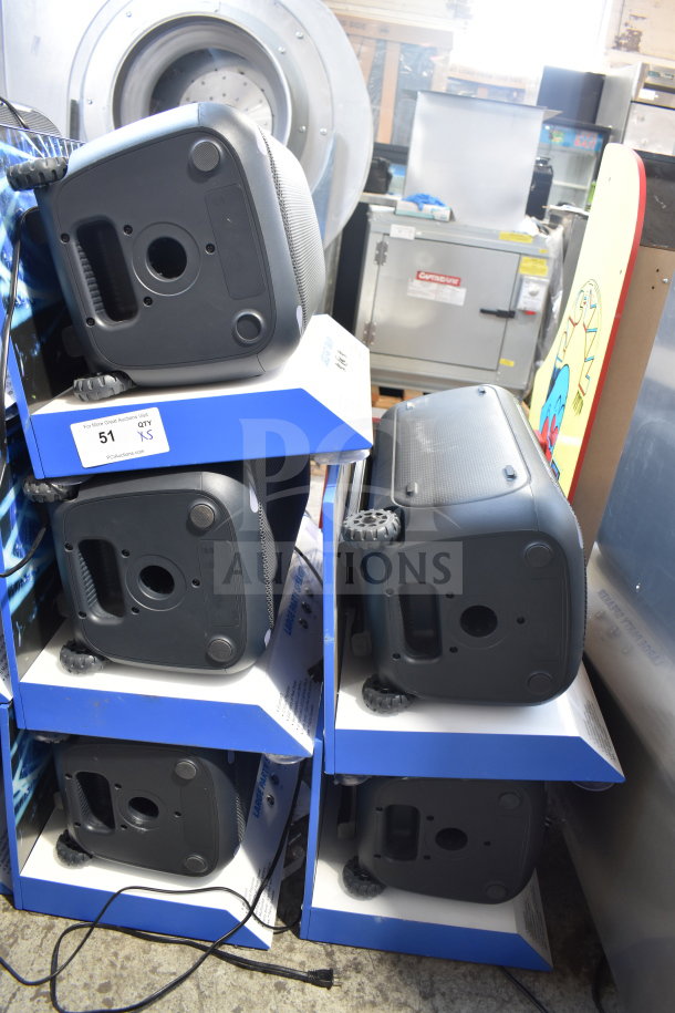 5 Onn Large Party Speakers in store display, stacked, featuring durable black casing and wheels, in good condition.