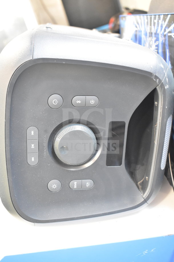 Onn Large Party Speaker display unit, features control buttons, volume knob, Bluetooth function; sturdy condition visible.