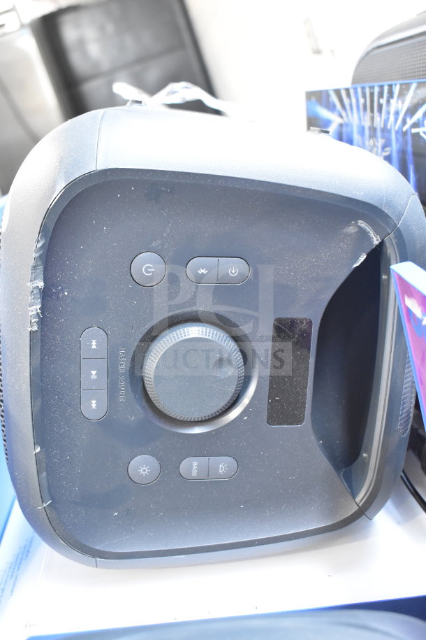 Onn Large Party Speaker with control panel showing power, Bluetooth, and volume buttons. Slight wear visible on edges.