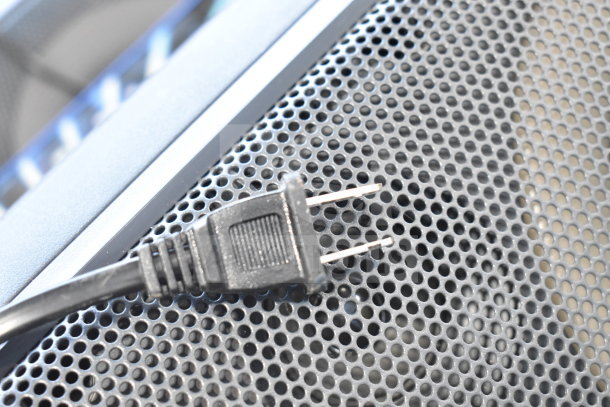 Onn large party speaker with a power cord on perforated metal grille, new condition, suitable for store display.