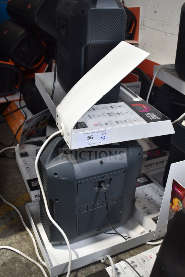 3-store display featuring Ion speakers, labeled "56 QTY X3", showcasing connectivity features. Good condition.